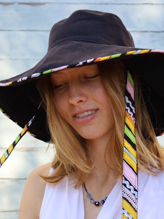 Black wide brimmed sun hat with multi-coloured chin straps and detailing