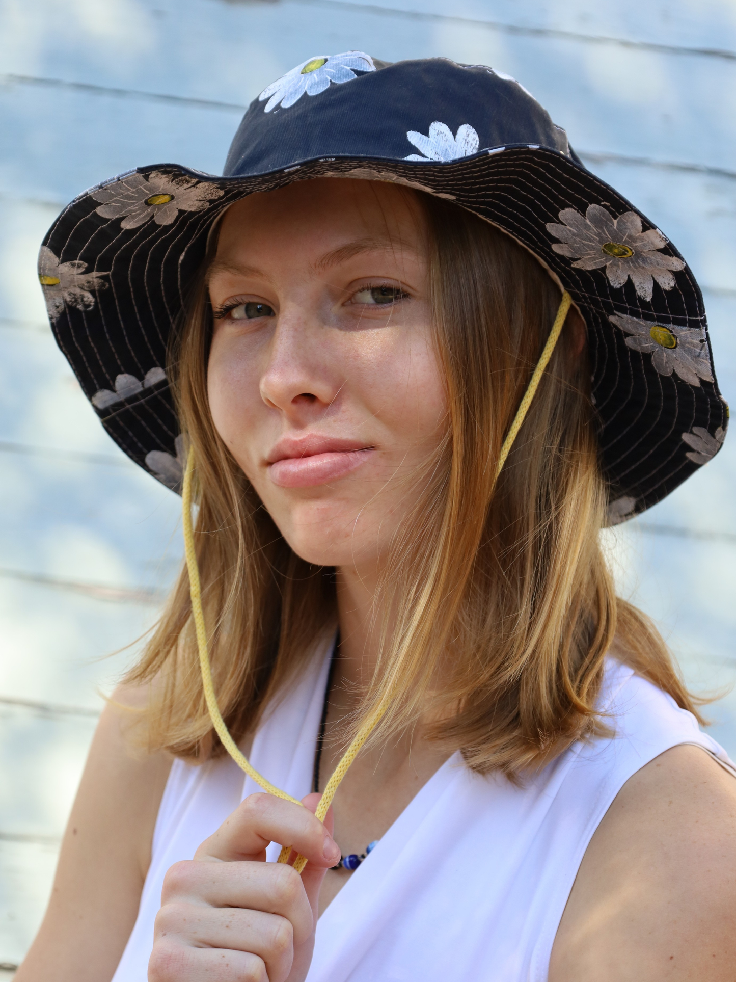Navy fishermen hat with white daisy print. Made in SA