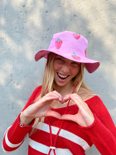 Strawberry pink hat with wide brim and red string