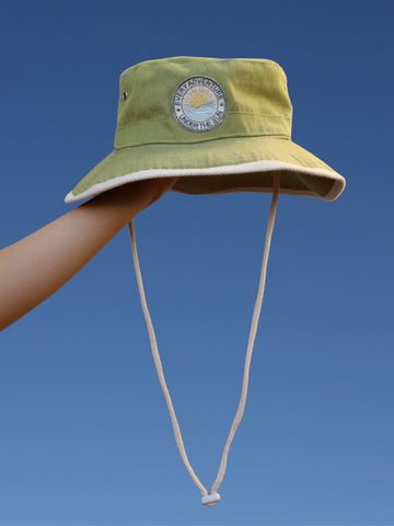 Green Every Adventure Under the Sun Hat held in the sky