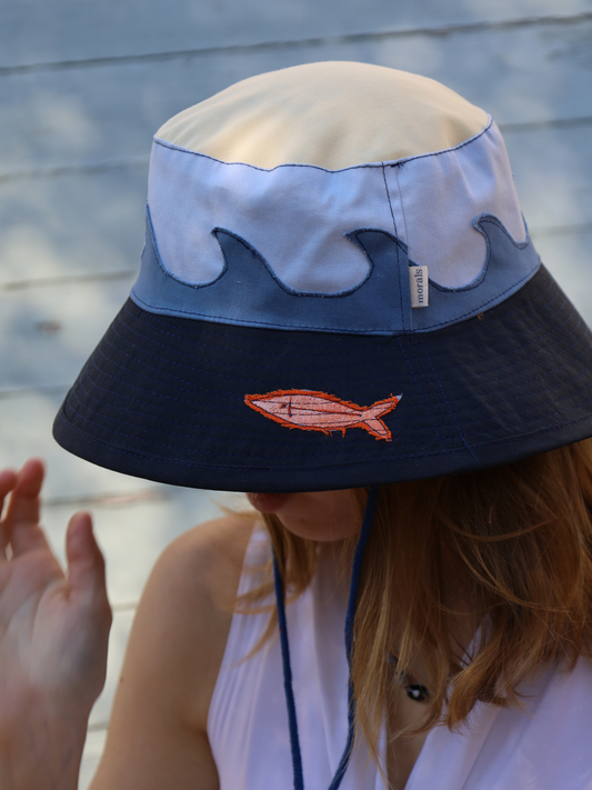Surfer style hat with blue waves and a fish pattern