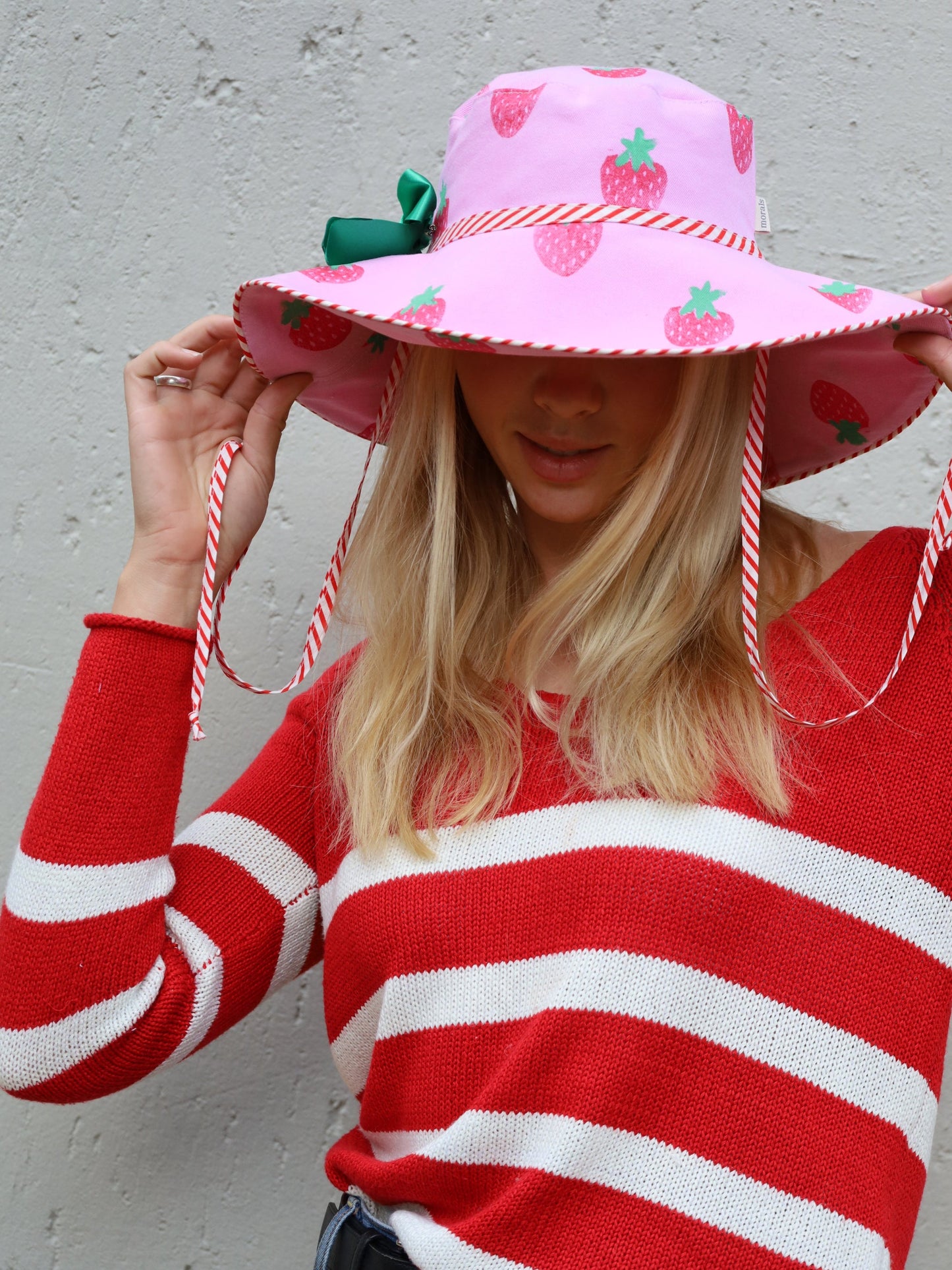 Handmade wide brimmed sun hat with strawberry print in pink