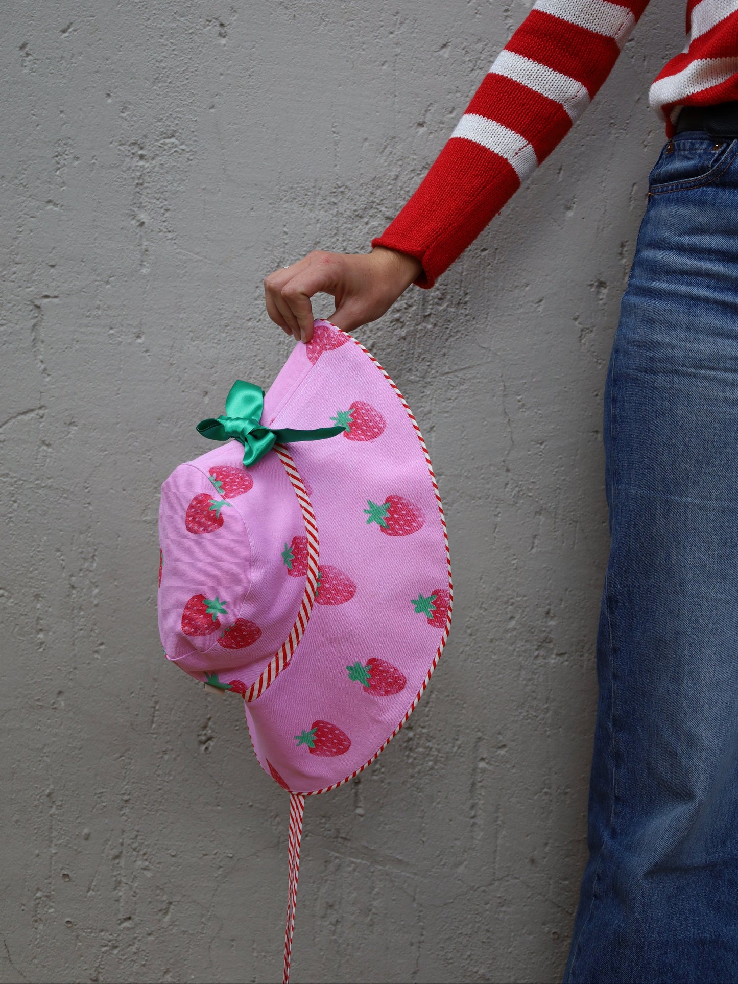 Pink wide brimmed sun hat with strawberry print